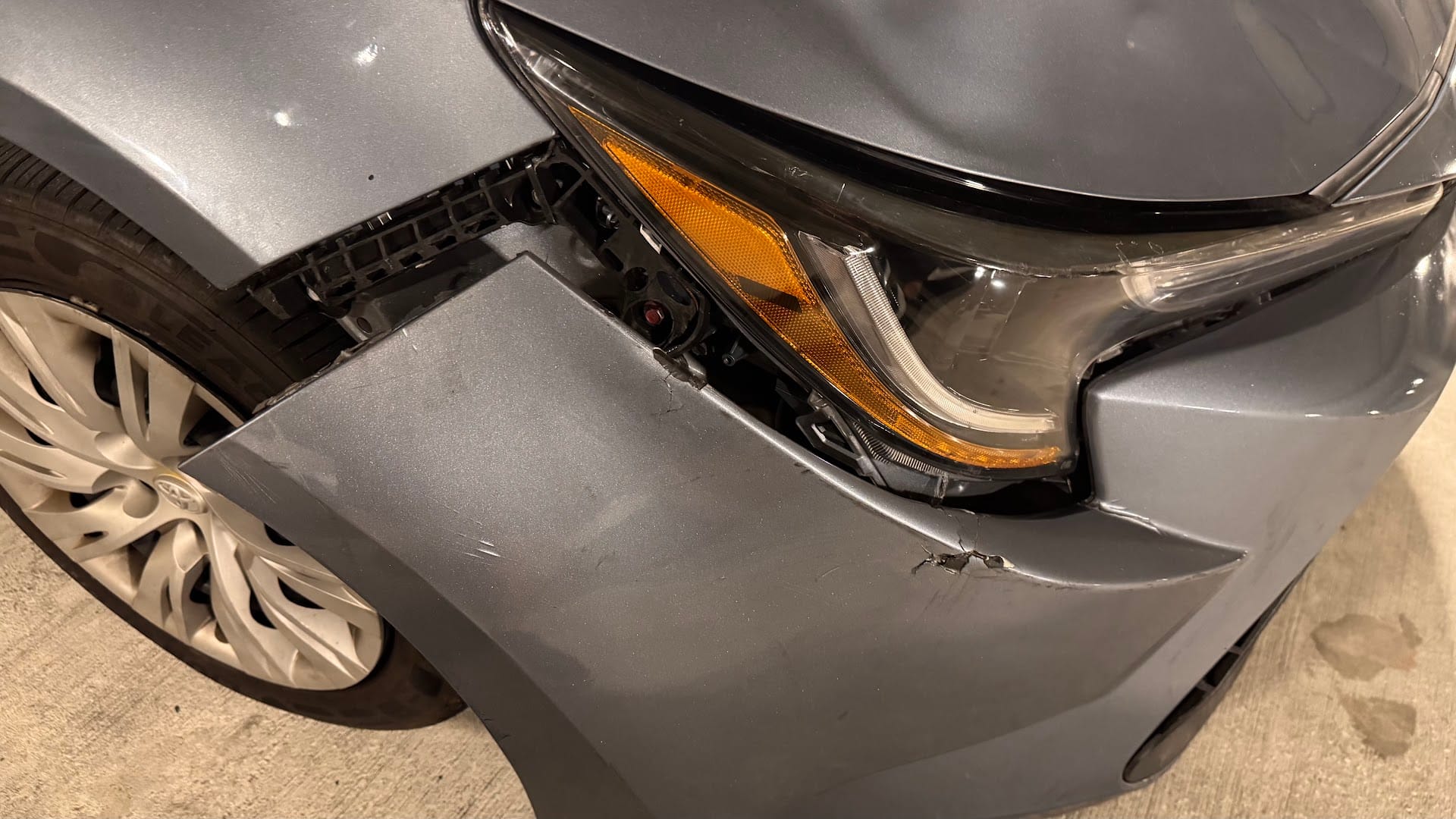 Toyota Corolla with front bumper and headlight damage before repair