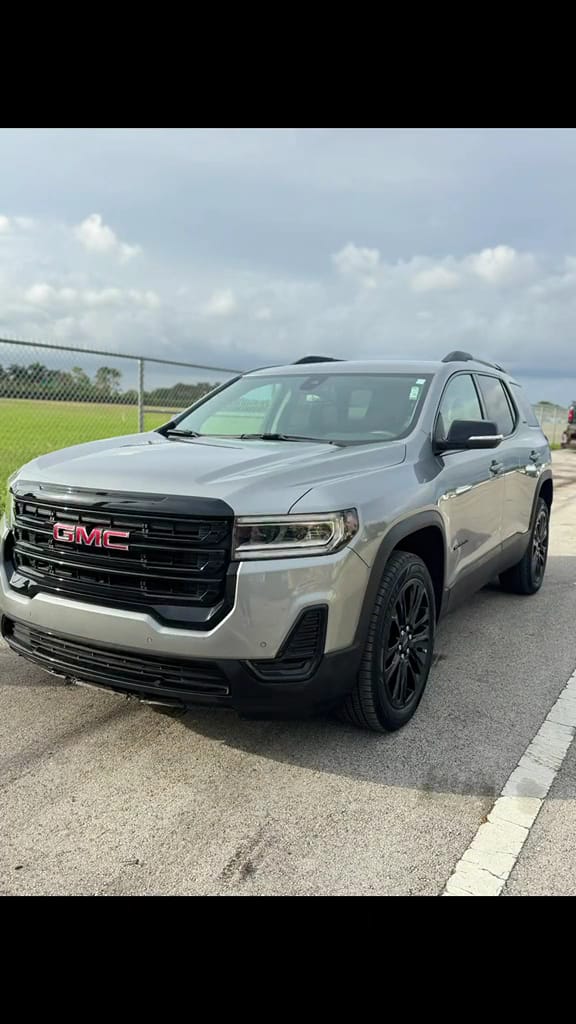 GMC Acadia with repaired front end outside the shop