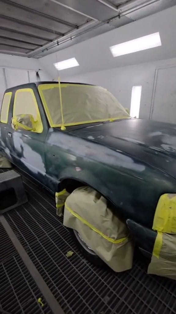 The same Ford Ranger masked with tape and paper inside the KAG paint booth