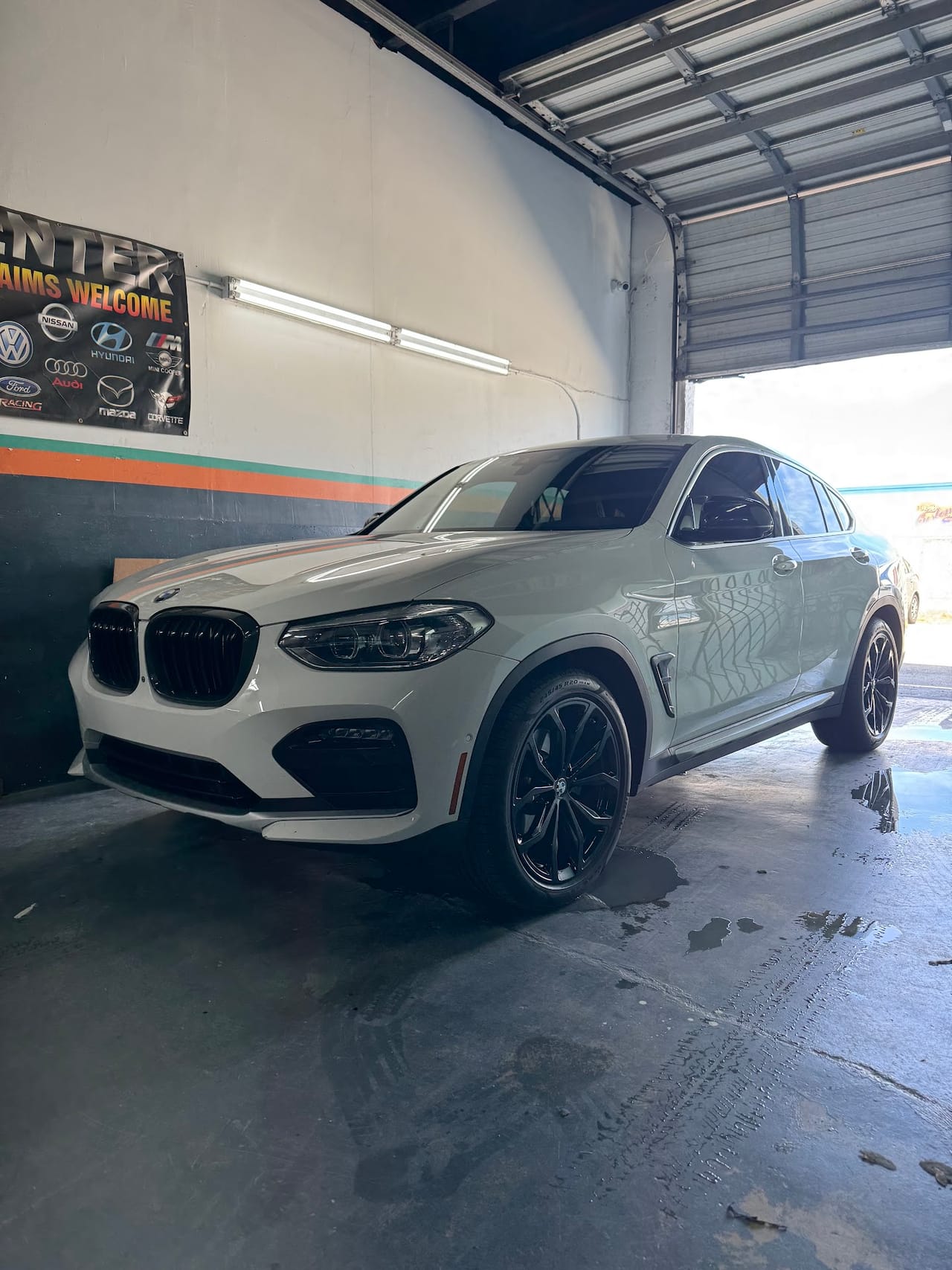BMW X4 M inside the KAG Auto Collision Center shop after bodywork