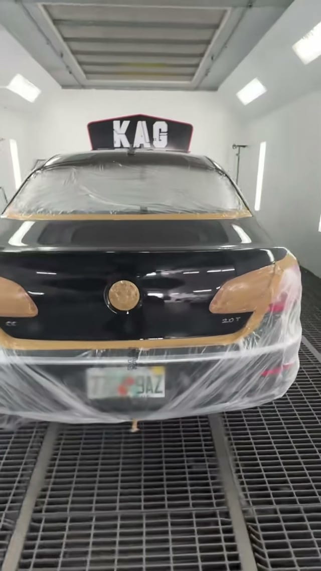 VW CC fully masked with tape and plastic inside the KAG paint booth